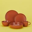 Essential dinnerware set in terracotta with plats bowls and mug