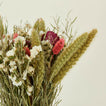 Close up view of pink strawflower dried floral bouquet.