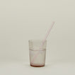 Glass Tumbler in Blush with straw and water.