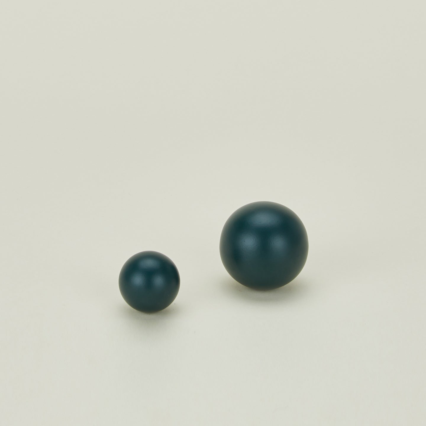 Small and large sphere knob in Dark Peacock.