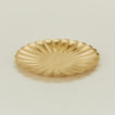 Close up view of large brass petal plate 