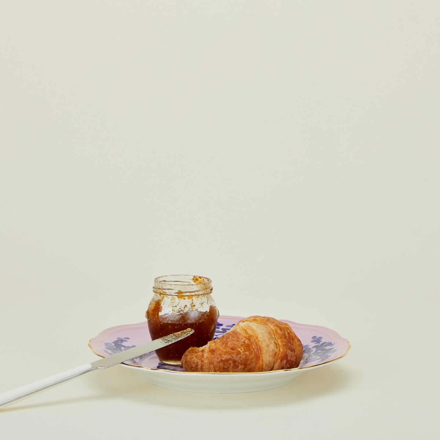 Ginori dinner plate in azalea with croissant, jam, and knife