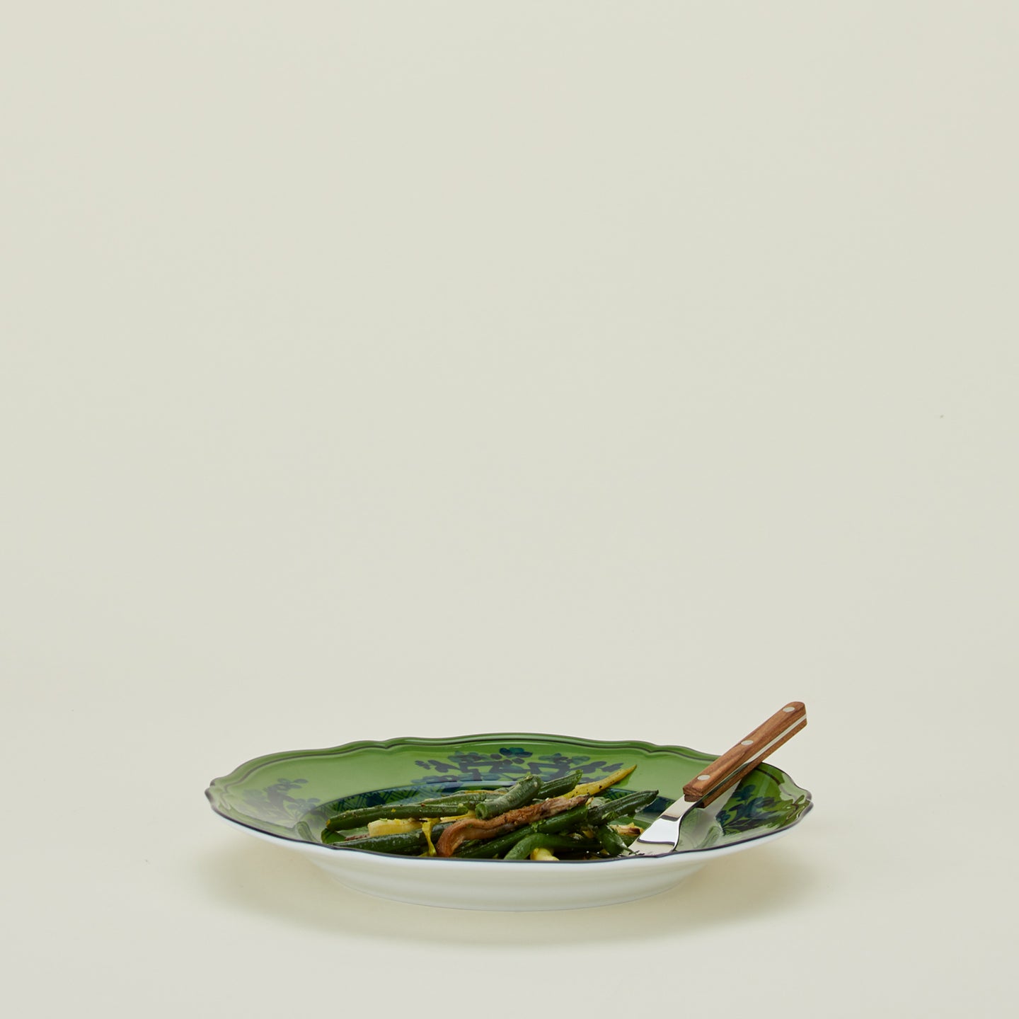 Ginori dinner plate in malachite with fork and green beans