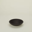 A close up  of a 9” ebonized oak  wood bowl.