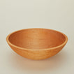 A close up  of a 17” maple wood bowl.