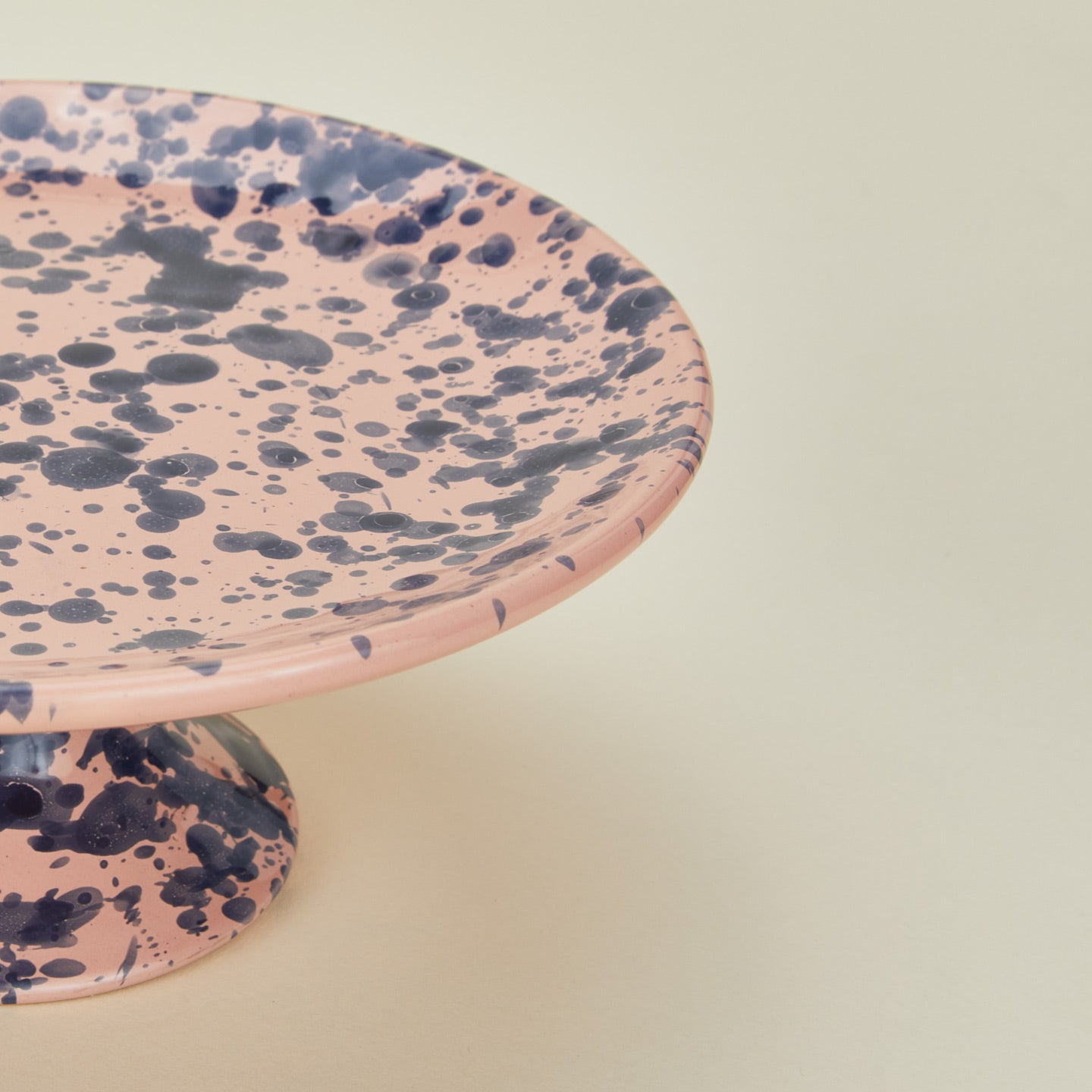 Close up view of Splatter cake stand in pink and blue