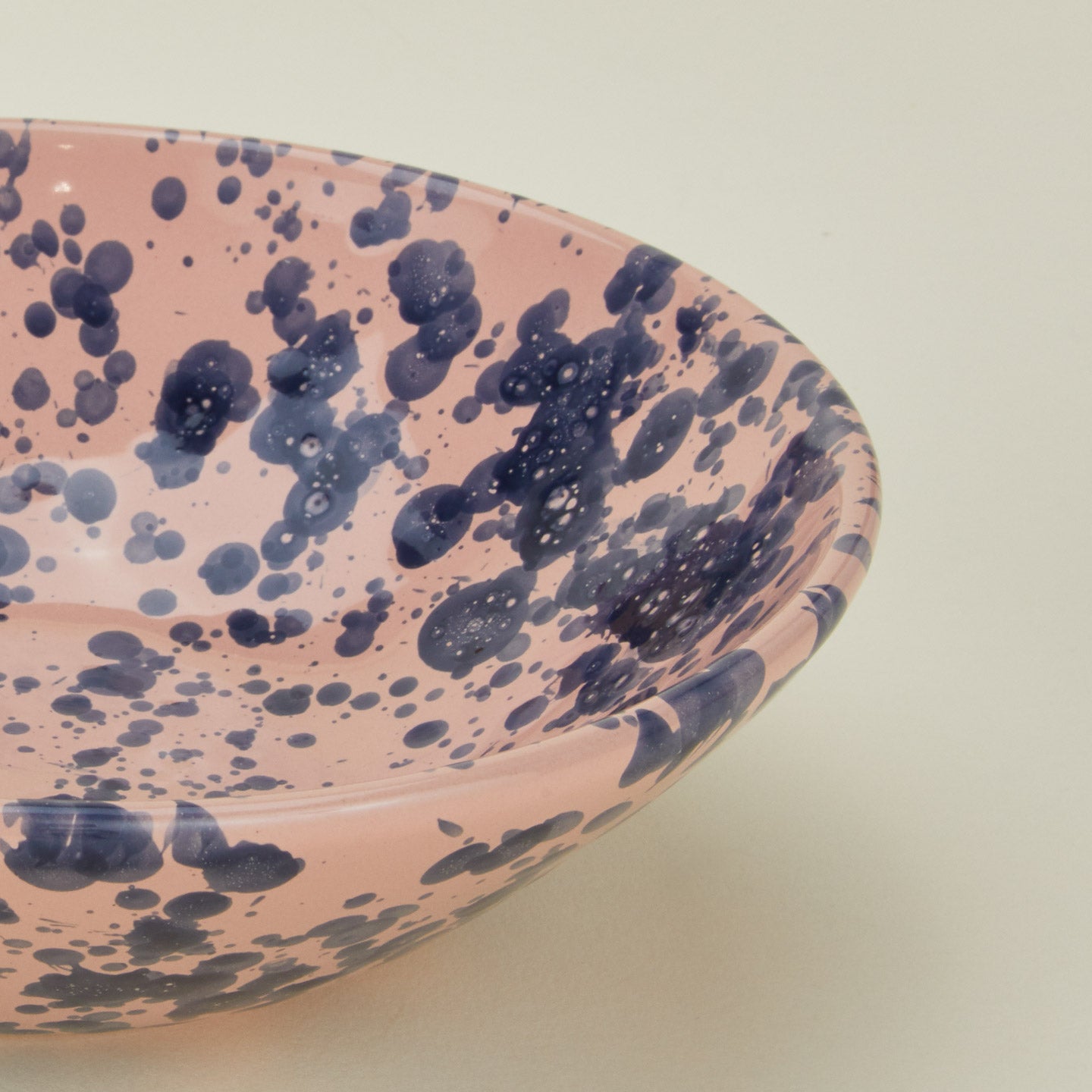 Close up view of Splatter low bowl in pink and blue
