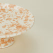 Close up view of Splatter cake stand in tan and ivory