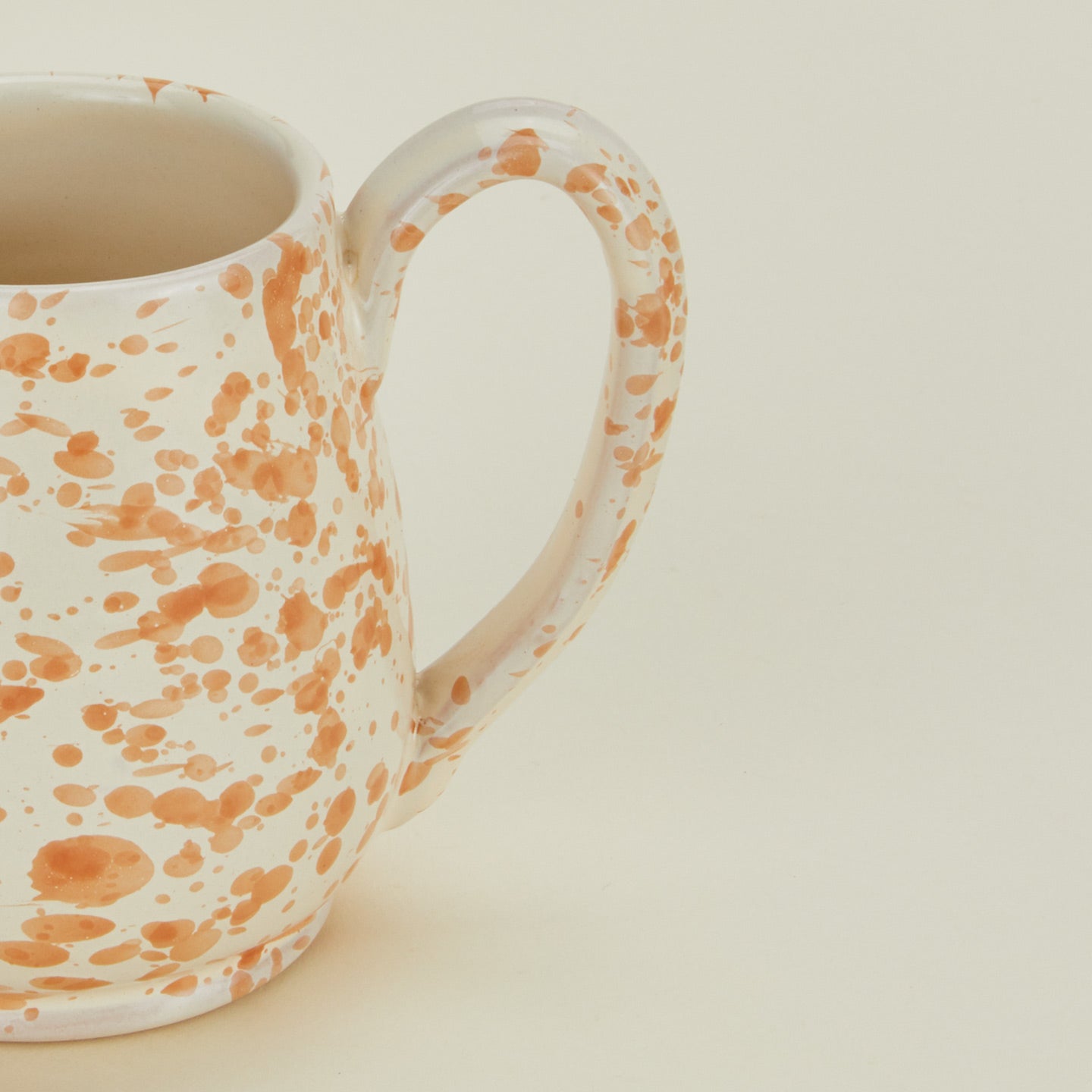 Close up view of Splatter mug in tan and ivory