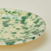 Close up view of Splatter dinner plate in yellow and green