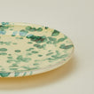 Close up view of Splatter salad plate in yellow and green