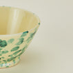 Close up view of Splatter small bowl in yellow and green