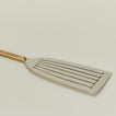 Close up view of Simple metal fish spatula in brass