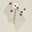 Simple metal spatula in brass with dishtowel and brazil nuts