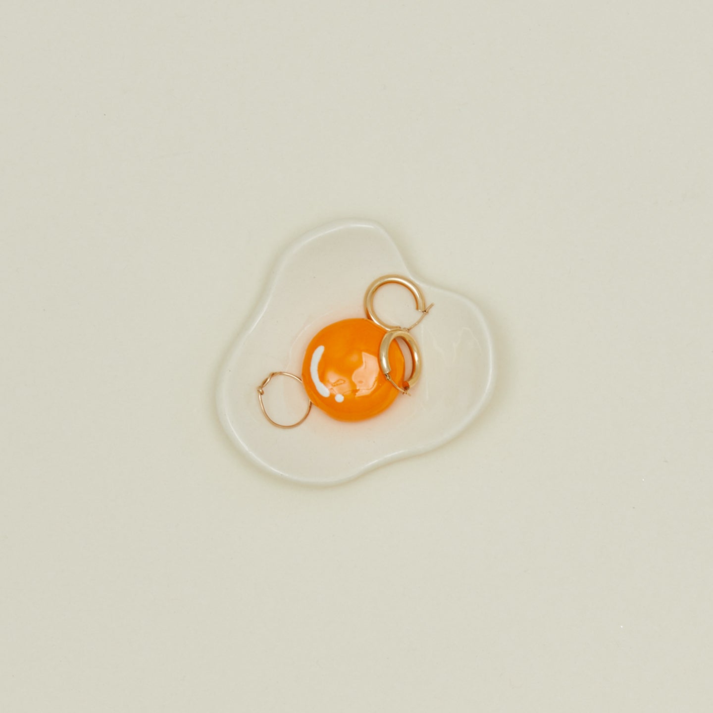 Overhead view of Egg Ceramic Dish with earrings